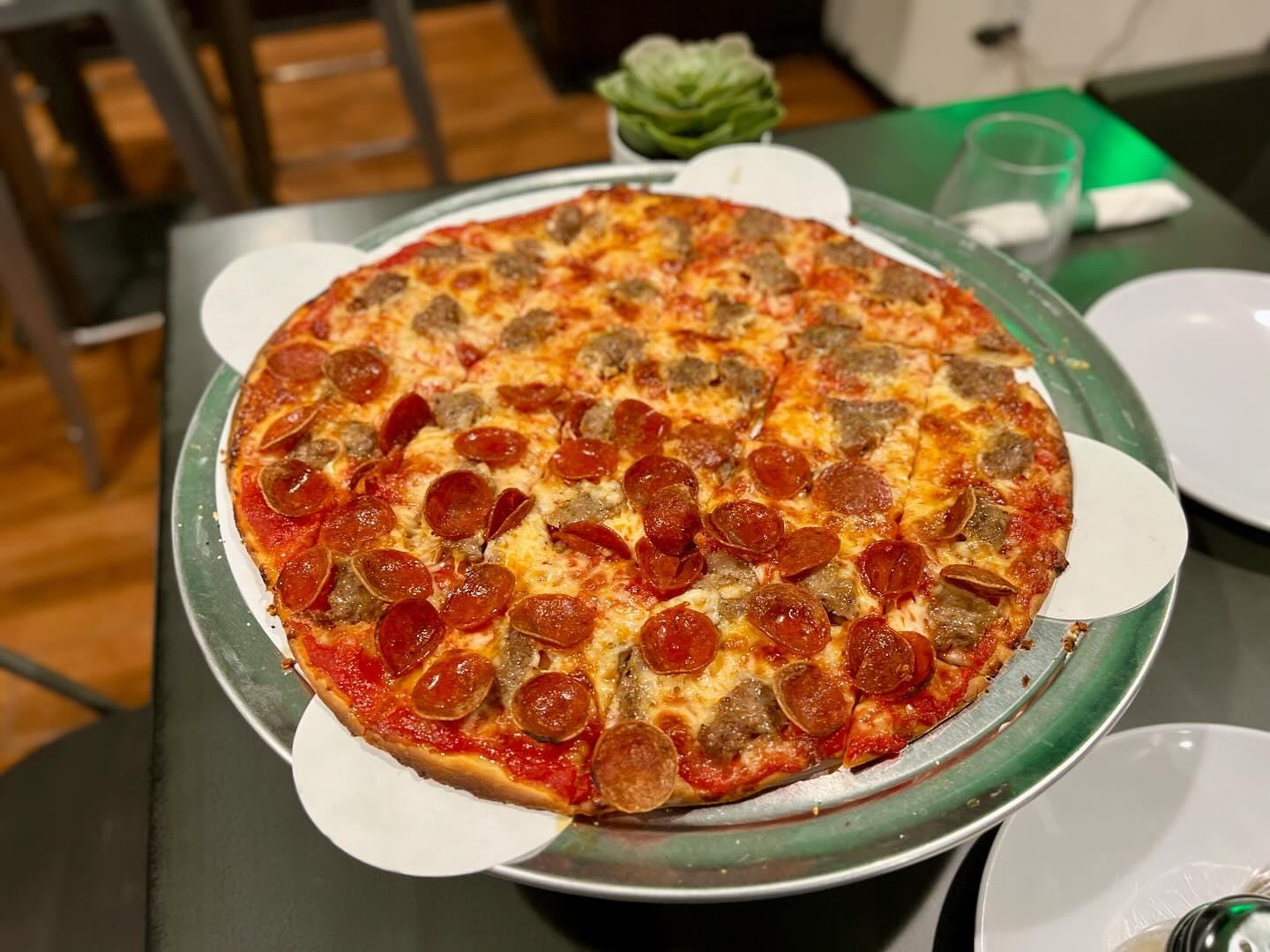 A pizza on a plate

Description automatically generated