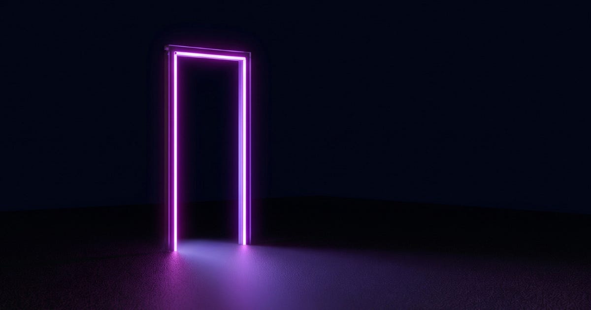 An empty doorway outlined in glowing magenta light, standing alone on a dark surface with purple light spilling through the opening. An empty doorway outlined in glowing magenta light, standing alone on a dark surface with purple light spilling through the opening.