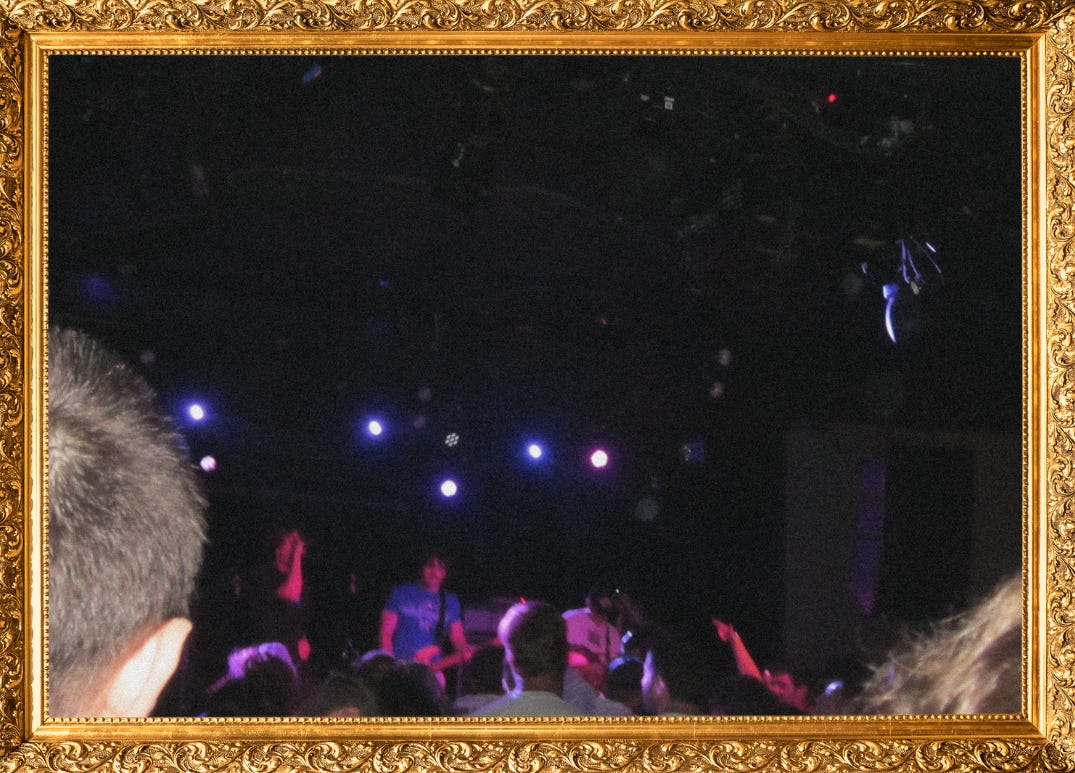 Blurry picture of One Step Closer on stage.