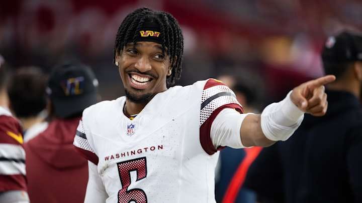 Sep 29, 2024; Glendale, Arizona, USA; Washington Commanders quarterback Jayden Daniels (5) celebrates in the closing seconds of the game against the Arizona Cardinals at State Farm Stadium. Mandatory Credit: Mark J. Rebilas-Imagn Images