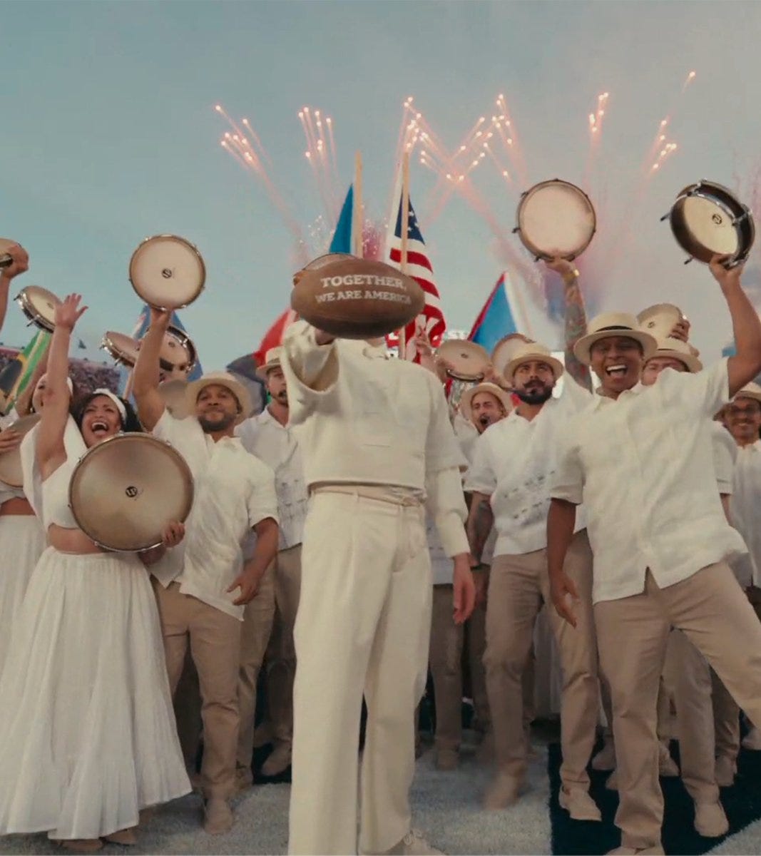 Bad Bunny held up a football at the end of his Super Bowl halftime show that reads: "Together, We Are America" Bad Bunny held up a football at the end of his Super Bowl halftime show that reads: "Together, We Are America"