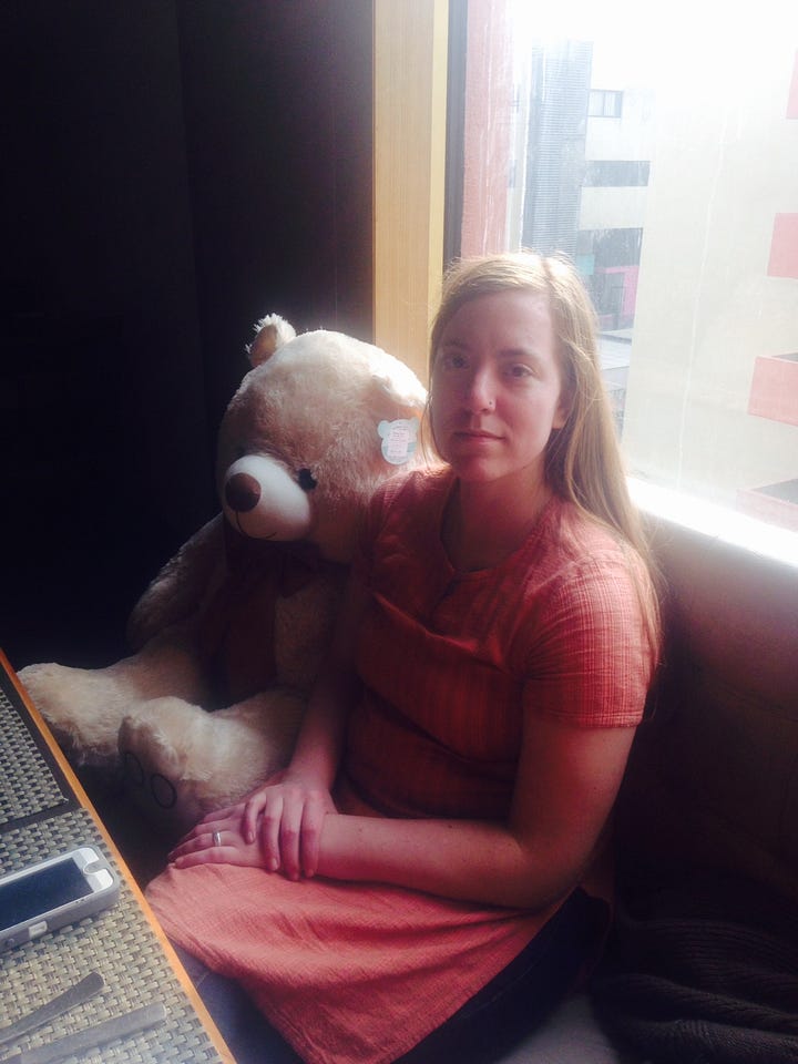 On the left, Katie looks very sad in India, sitting with a teddy bear the same size as her; on the right, a selfie of Katie on a train, genuinely smiling for the first time in years