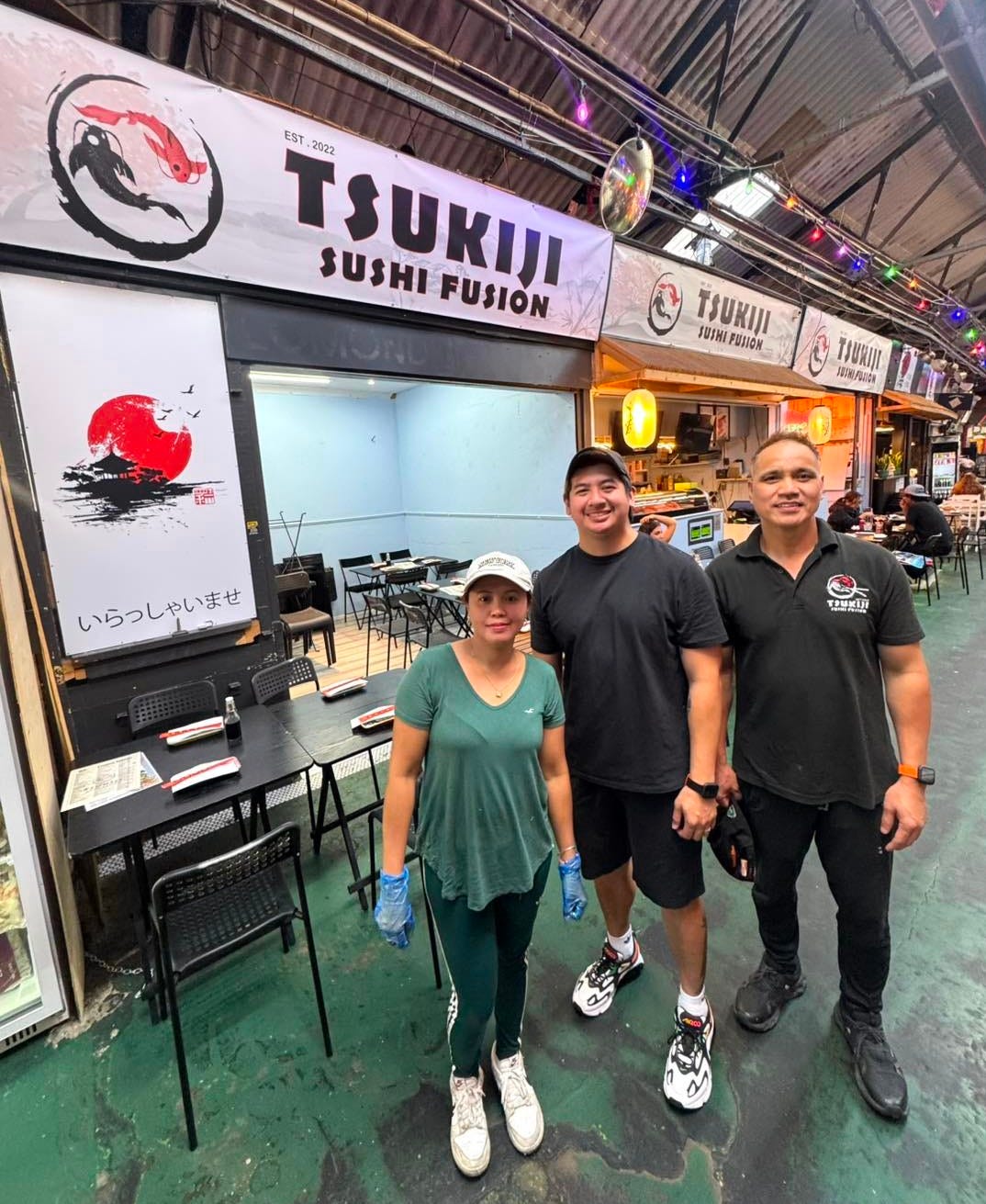 May be an image of 4 people, sushi and text