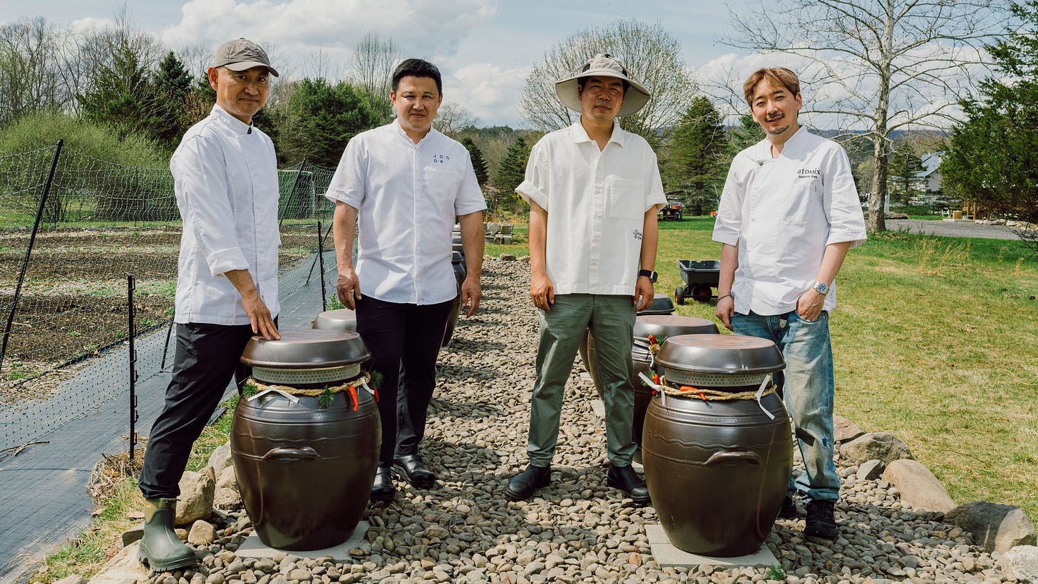 At First Hand Farm chefs Ok Dongsik Changho Shin Hoyoung Kim JP pose with the onggi earthenware fermentation vessels...