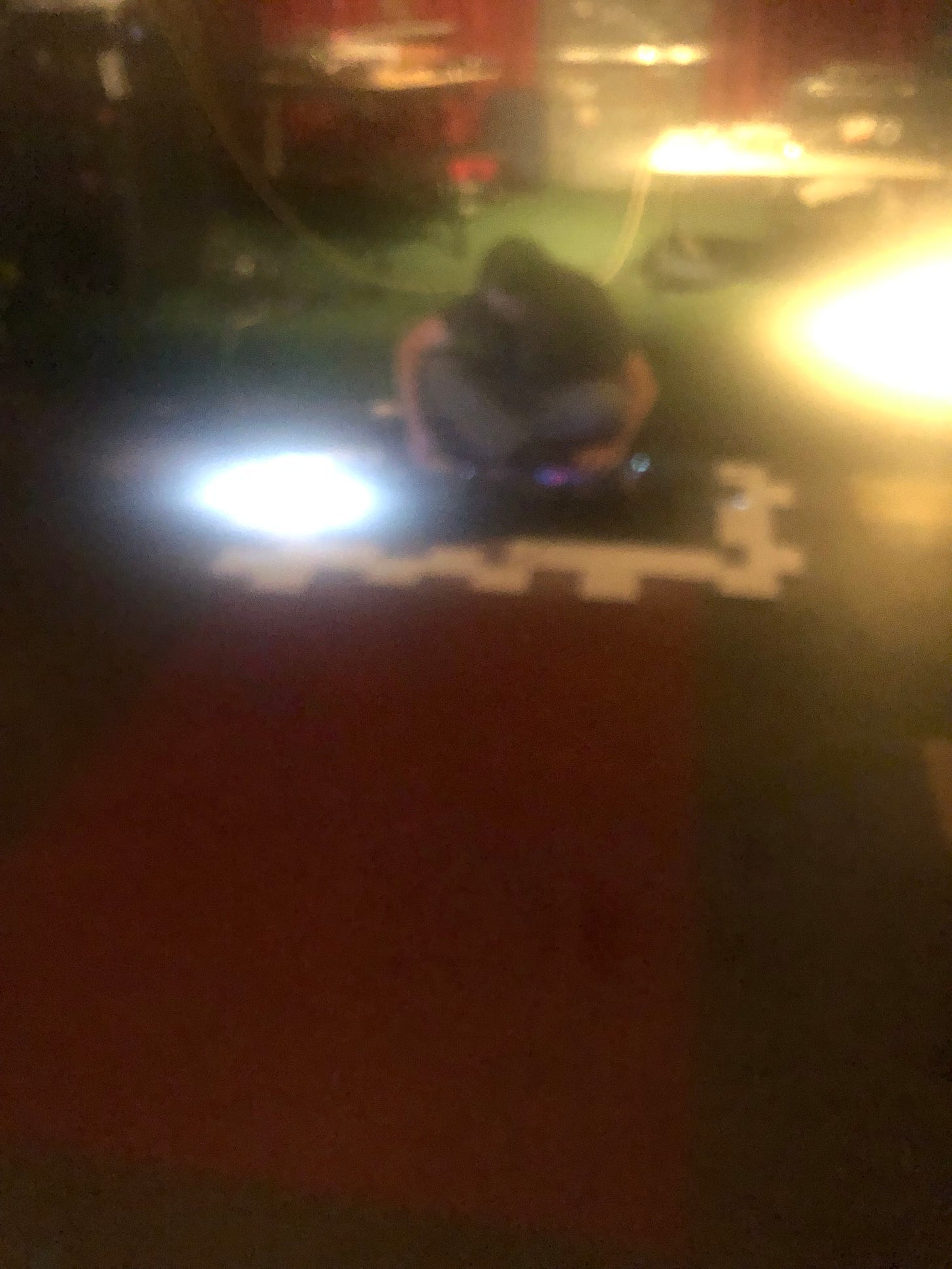 The Zero Collective at Le Voyeur in Olympia,Washington sitting in front of their many machines, many white square beyond those which are pulsating with the tunes they make in real time.