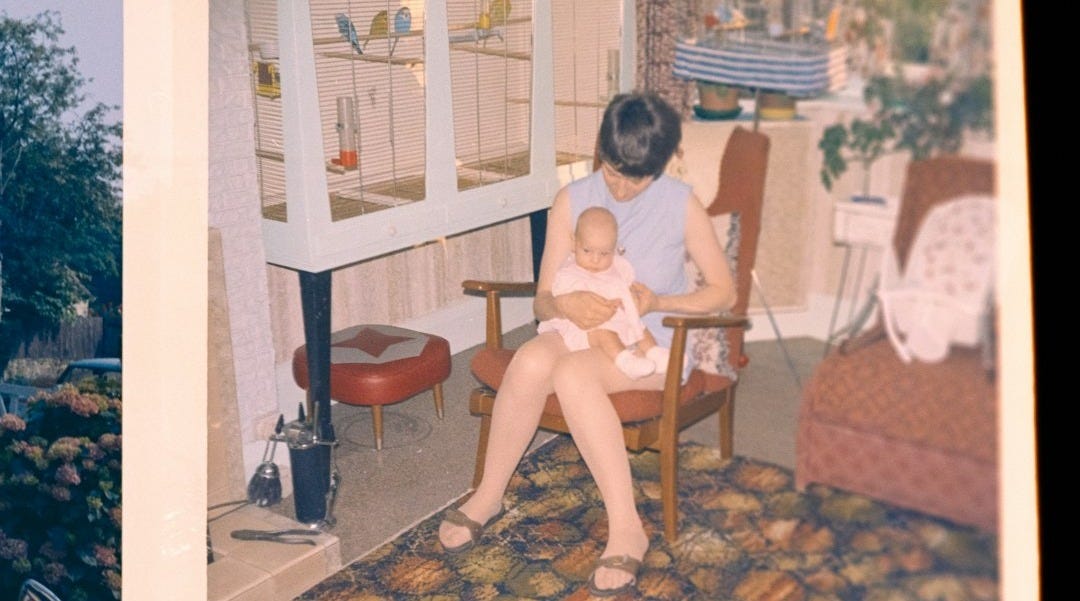 Woman holding a baby in a chair Woman holding a baby in a chair