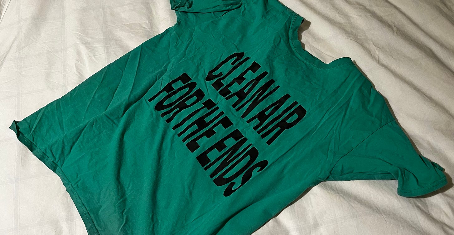 Photo of a green T-shirt saying Clean Air for the Ends