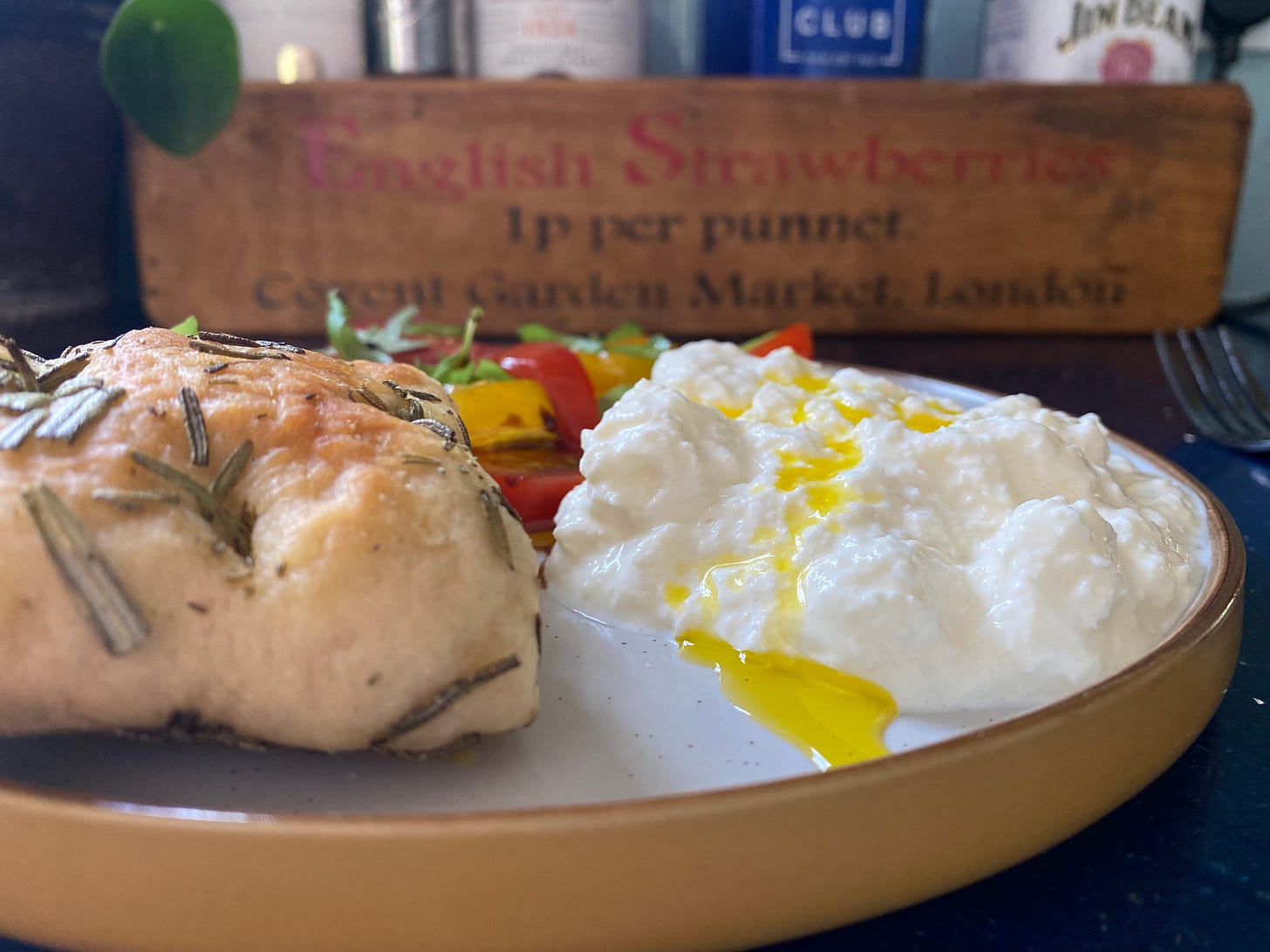 Plate with creamed mozzarella, focaccia and a tomato salad with fresh basil