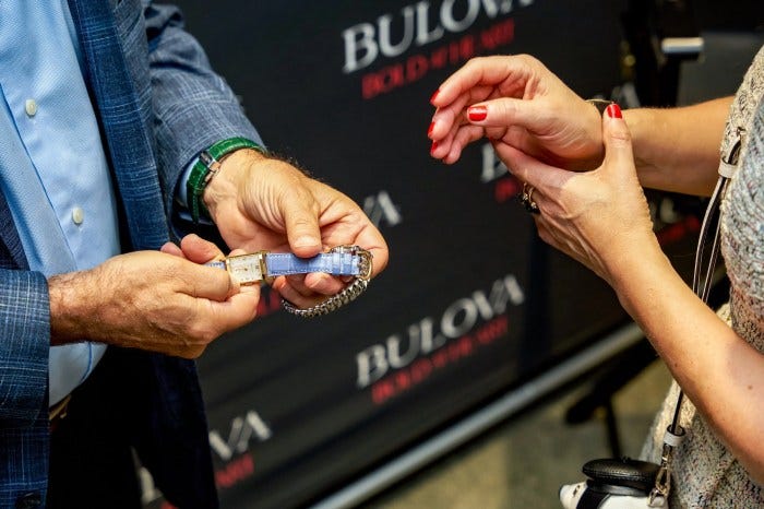 Bulova brand historian Carl Rosen examining the vintage Bulova owned by RedBar member Debbie Davis. Bulova brand historian Carl Rosen examining the vintage Bulova owned by RedBar member Debbie Davis.