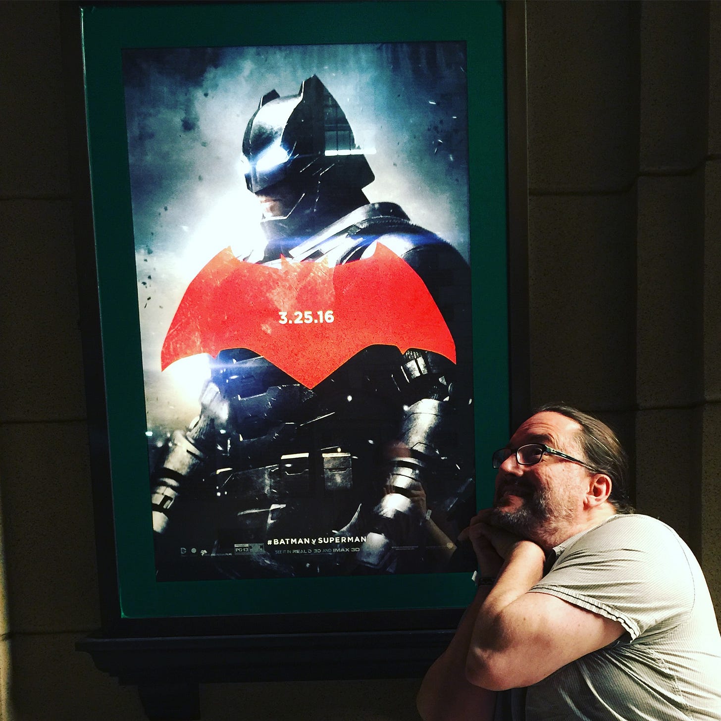 The author, looking up at a poster of Batfleck adoringly The author, looking up at a poster of Batfleck adoringly