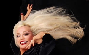A person with long blonde hair

Description automatically generated