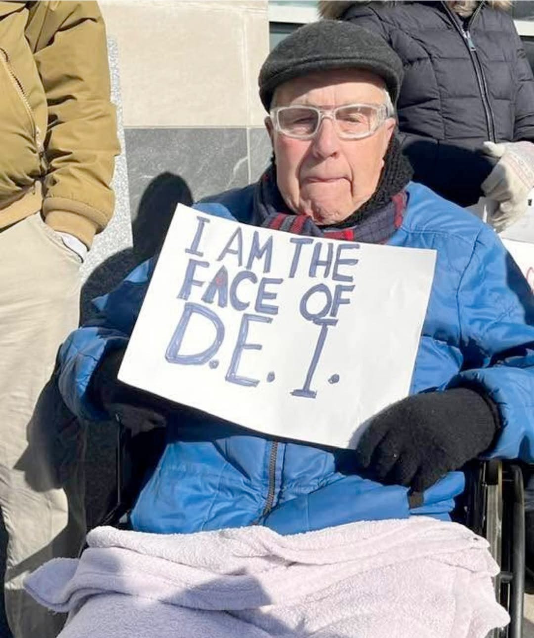Someone holding a sign that says "I am the face of D.E.I." at the Mondays With McCormick demonstration outside of Senator Dave Mccormick's office in Scranton Pennsylvania in February 2025. Someone holding a sign that says "I am the face of D.E.I." at the Mondays With McCormick demonstration outside of Senator Dave Mccormick's office in Scranton Pennsylvania in February 2025.