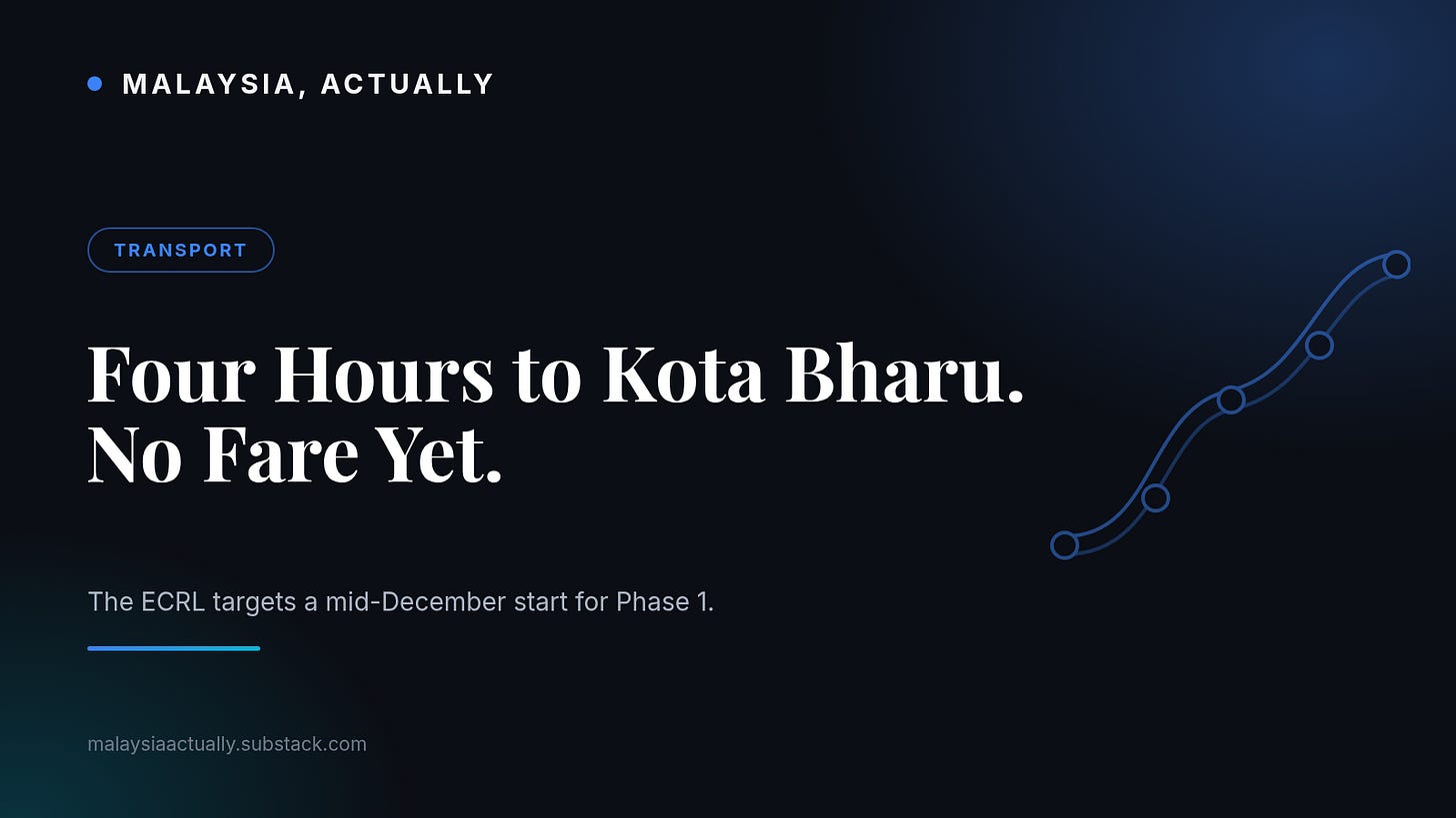 Blue title card reading Four Hours to Kota Bharu. No Fare Yet., with a rail line linking station dots and the Malaysia, Actually masthead Blue title card reading Four Hours to Kota Bharu. No Fare Yet., with a rail line linking station dots and the Malaysia, Actually masthead