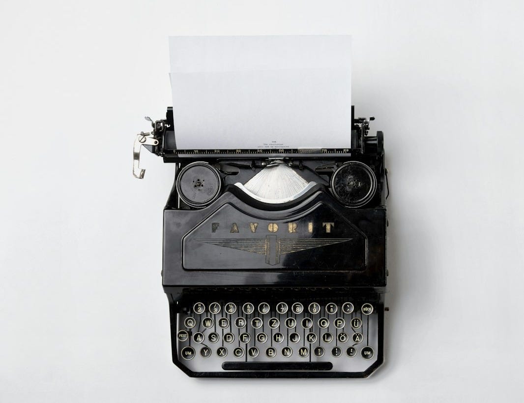 black Fayorit typewriter with printer paper
