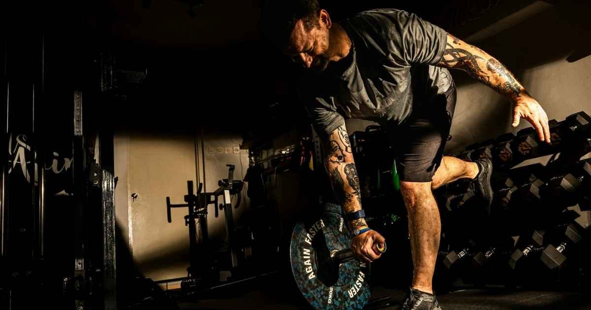 Man performing landmine single arm deadlift Man performing landmine single arm deadlift