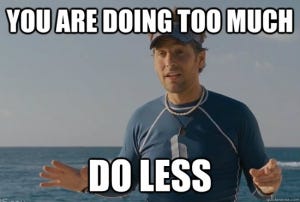 Paul Rudd standing in front of the ocean. The white text days "You are doing too much do less". Paul Rudd standing in front of the ocean. The white text days "You are doing too much do less".