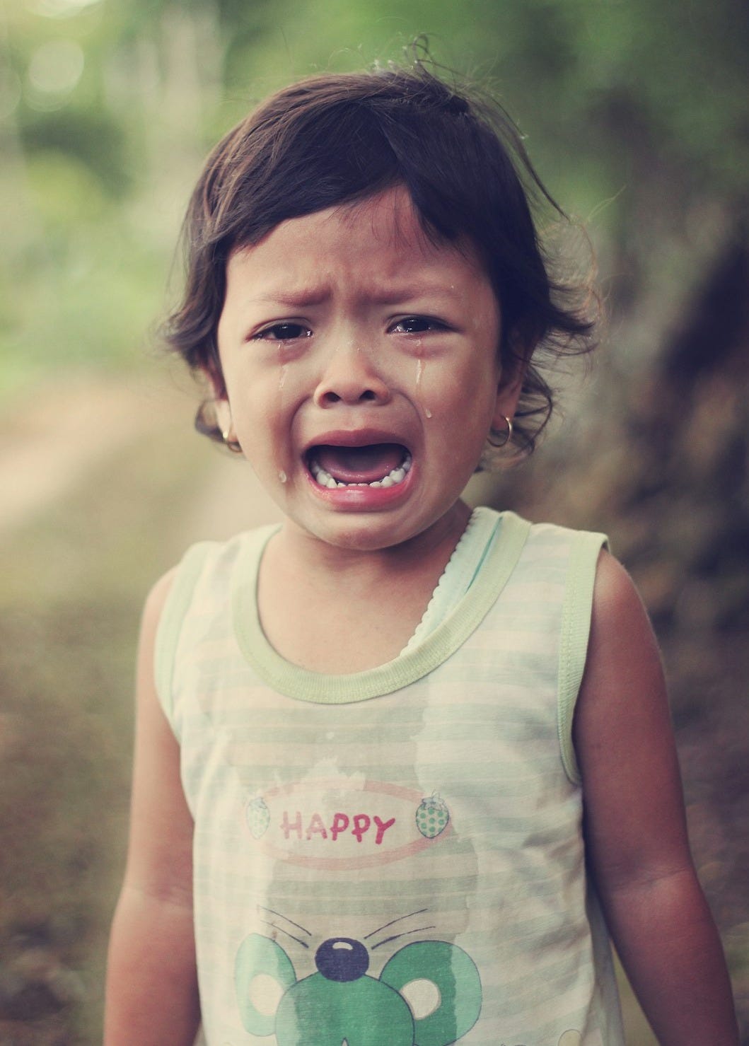 selective focus photography of girl crying