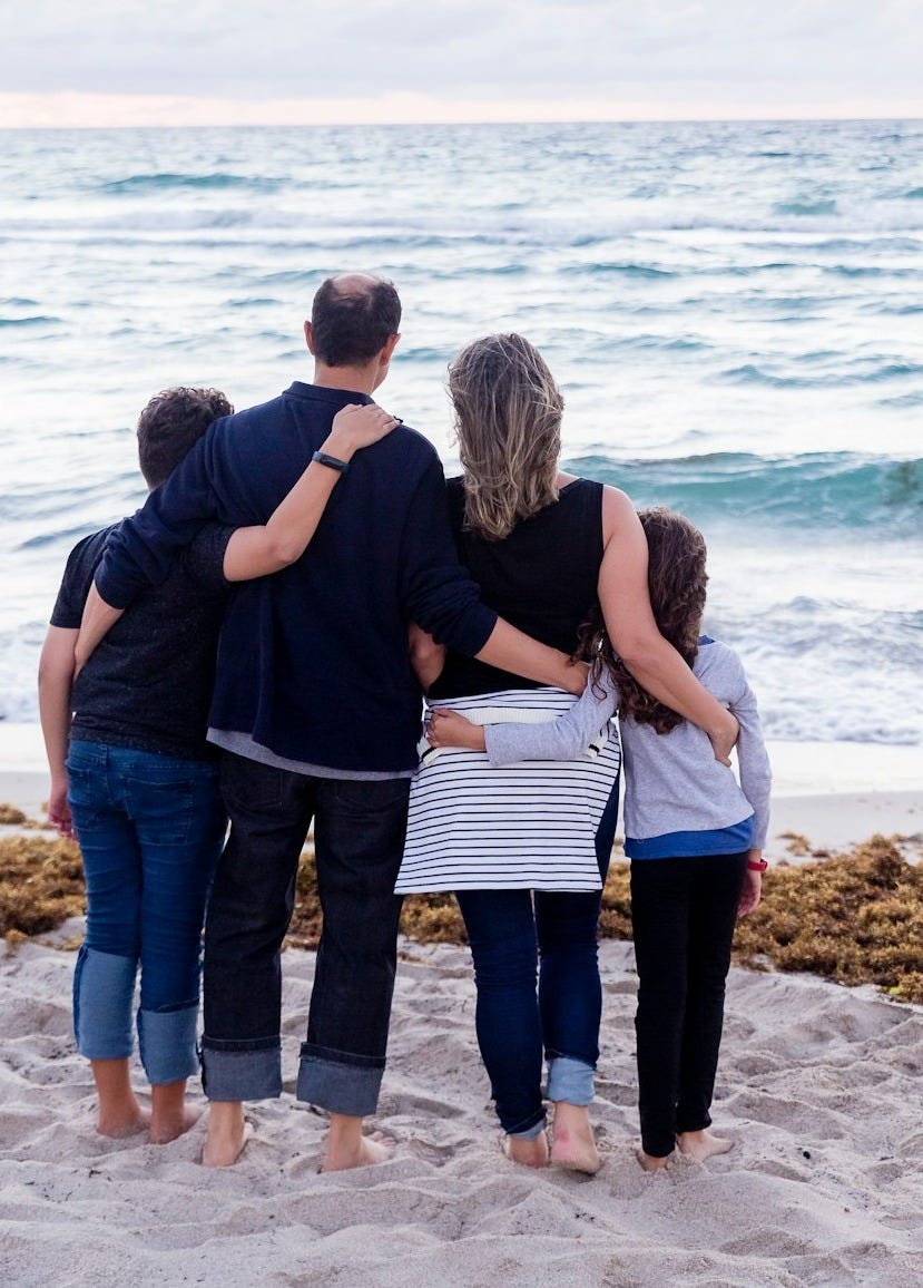 a family of four on a beach