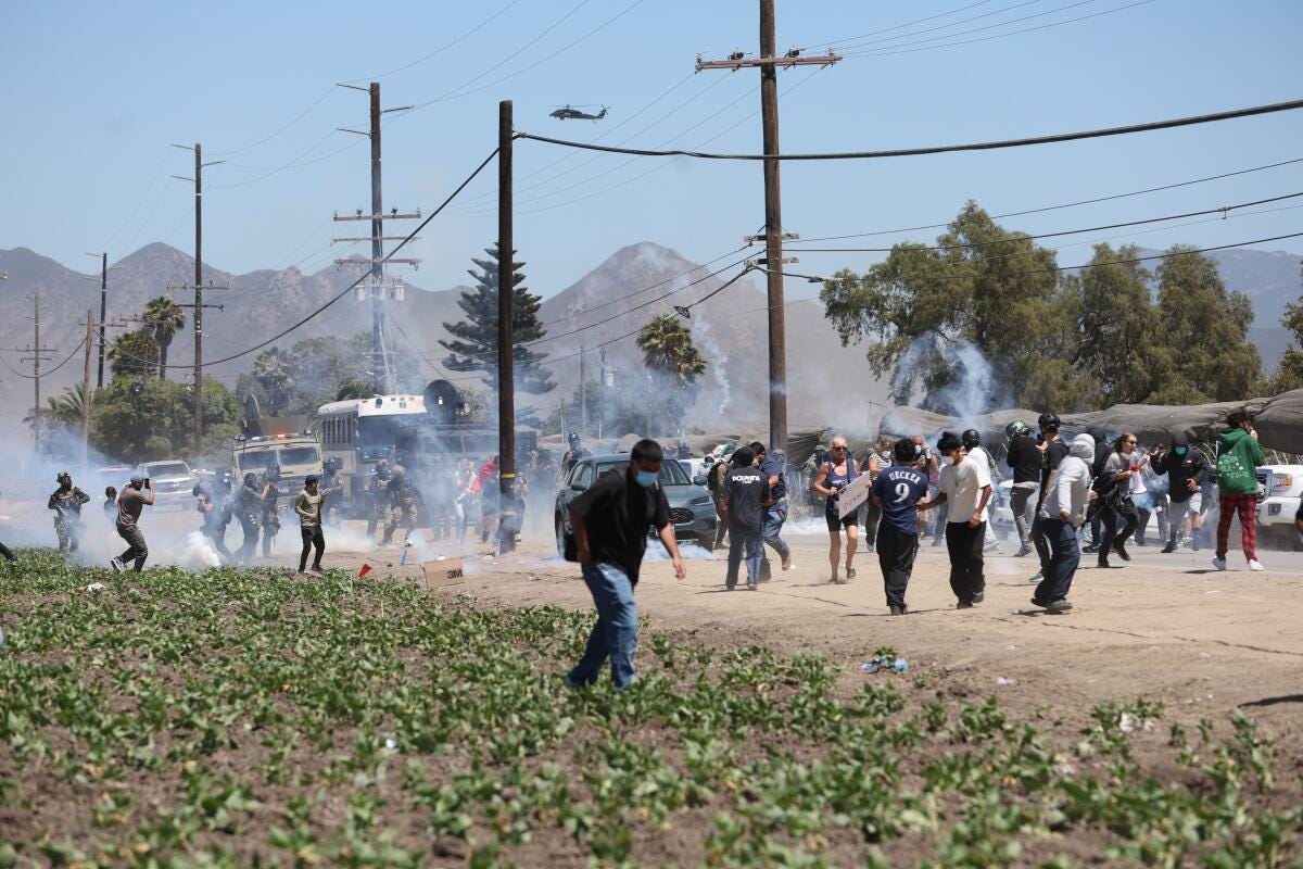 Tear gas disperses protesters on a rural road. Tear gas disperses protesters on a rural road.