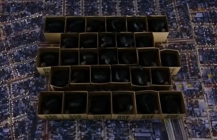 First image: An overhead view of 28 cardboard boxes filled with crouching Black men dressed in all black. Kendrick Lamar's cornrowed hair stands out at the center of these boxes. Second image: Nine large square stages are lit in a much larger, dark stadium.