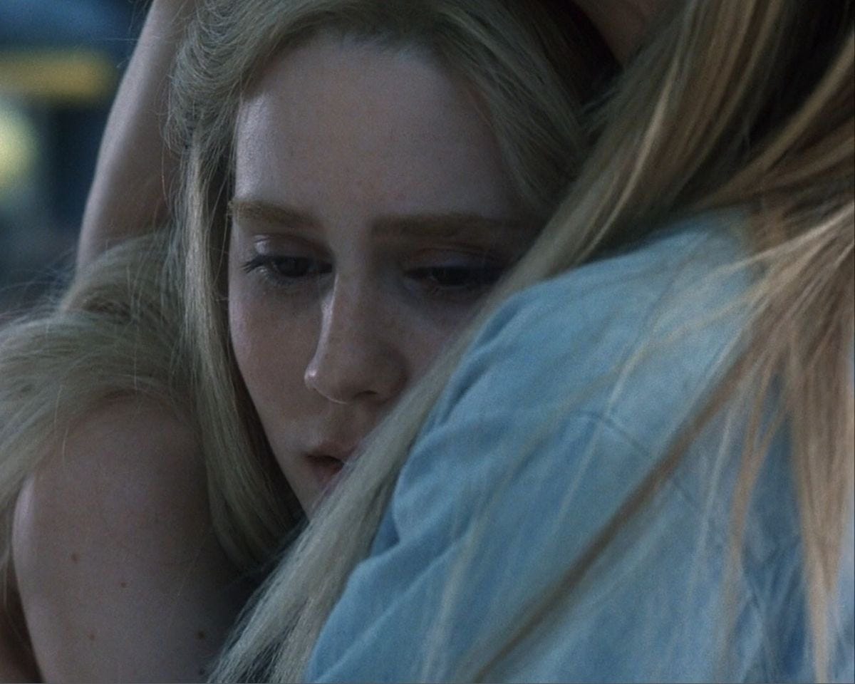 Michelle Pfeiffer and Alison Lohman in White Oleander sharing an emotional embrace, with Alison's character Astrid looking over Michelle's shoulder, reflecting the film's themes of loneliness, resilience, and complicated mother-daughter relationships. 