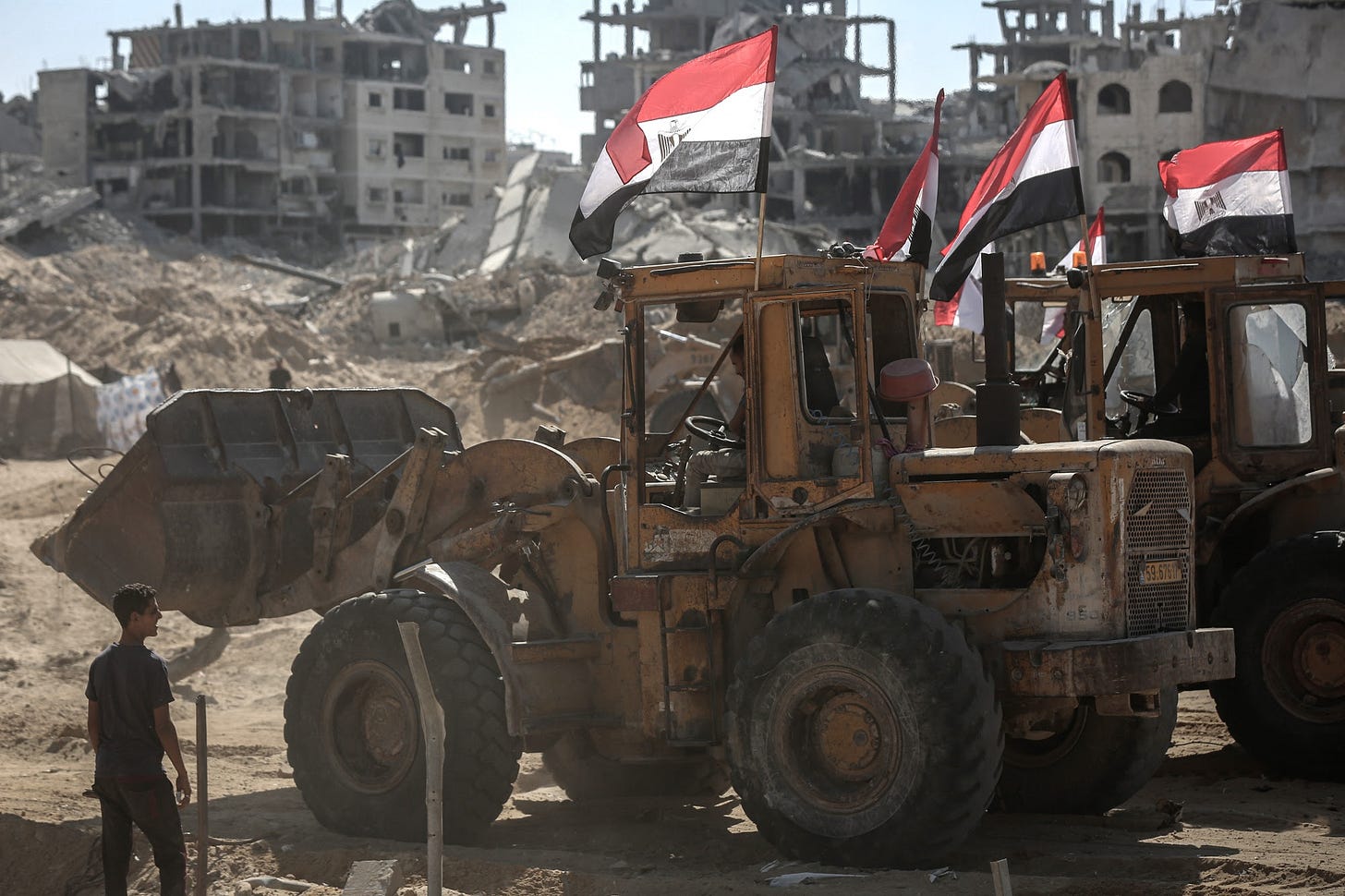 Bulldozers carrying Egyptian flags clear ground near destroyed buildings in Gaza City, Gaza, on Sunday, Oct. 19, 2025. Israel said it has resumed a truce with Hamas in Gaza after heavy fighting over the weekend, with the sides accusing each other of breaching a deal brokered by US President Donald Trump. Photographer: Ahmad Salem&#x2F;Bloomberg
