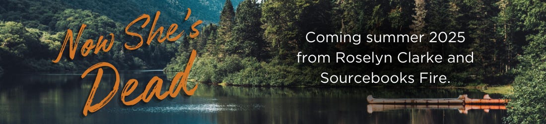 Forested mountain lake with dock in the background. Text reads, "Now She's Dead" in large, burnt orange script. Coming summer 2025 from Sourcebooks Fire. 