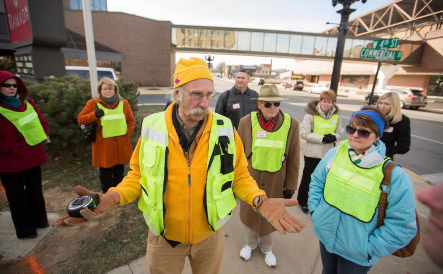 walkability expert Dan Burden talks to a group of people on a sidewalk during one of his walkability audits walkability expert Dan Burden talks to a group of people on a sidewalk during one of his walkability audits