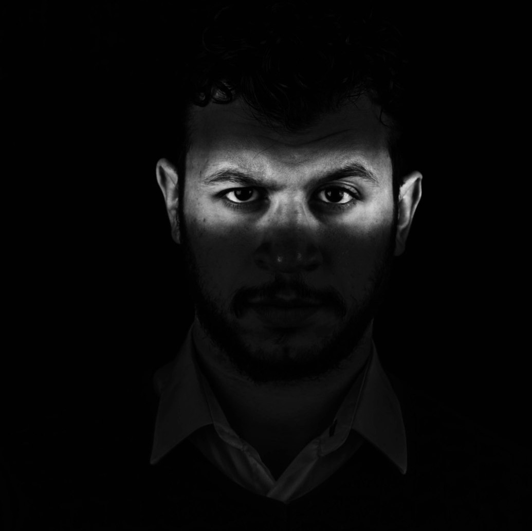 man in black collared shirt