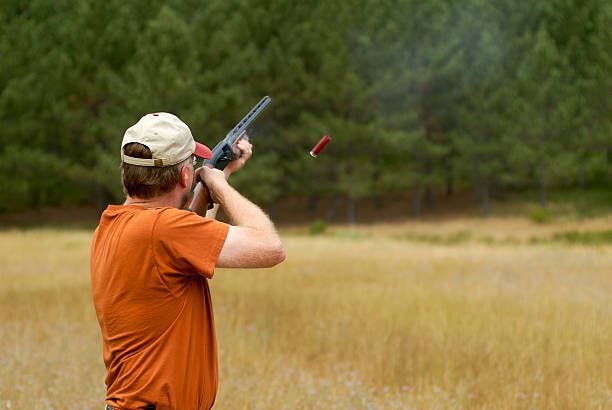 shooting a shotgun shell casing in air - skeet shooting stock pictures, royalty-free photos & images shooting a shotgun shell casing in air - skeet shooting stock pictures, royalty-free photos & images