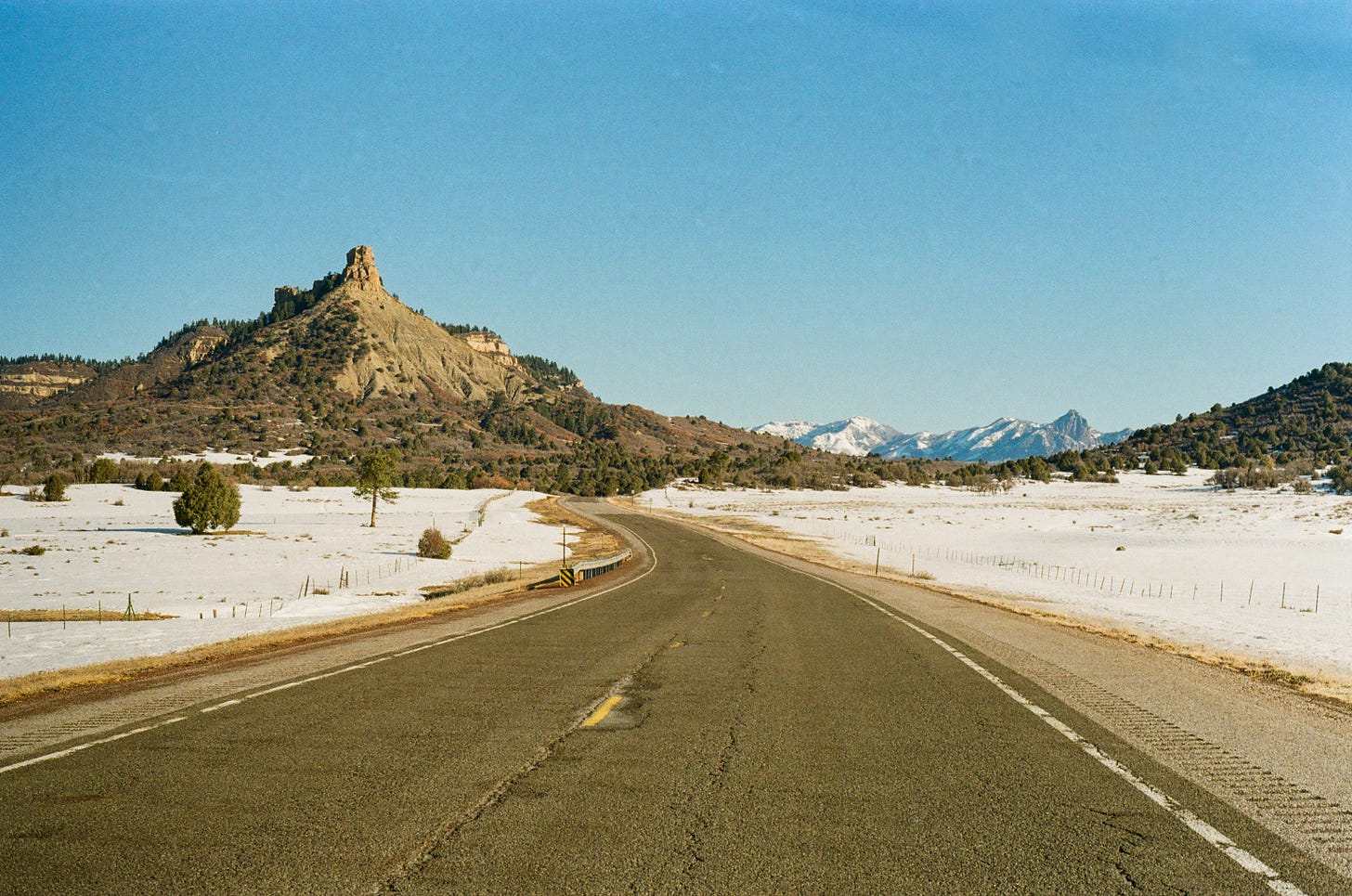 US-84 looking towards snowcapped mountains. Rio Arriba County, New Mexico