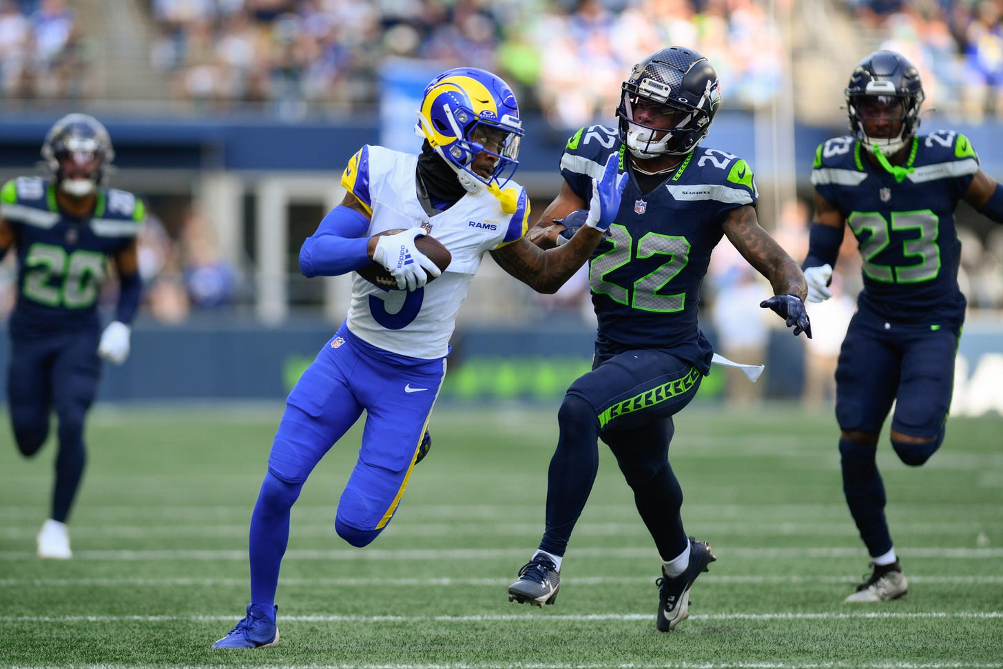 Sep 10, 2023; Seattle, Washington, USA; Los Angeles Rams wide receiver Tutu Atwell (5) carries the ball after a catch while Seattle Seahawks cornerback Tre Brown (22) chases during the second half at Lumen Field. 