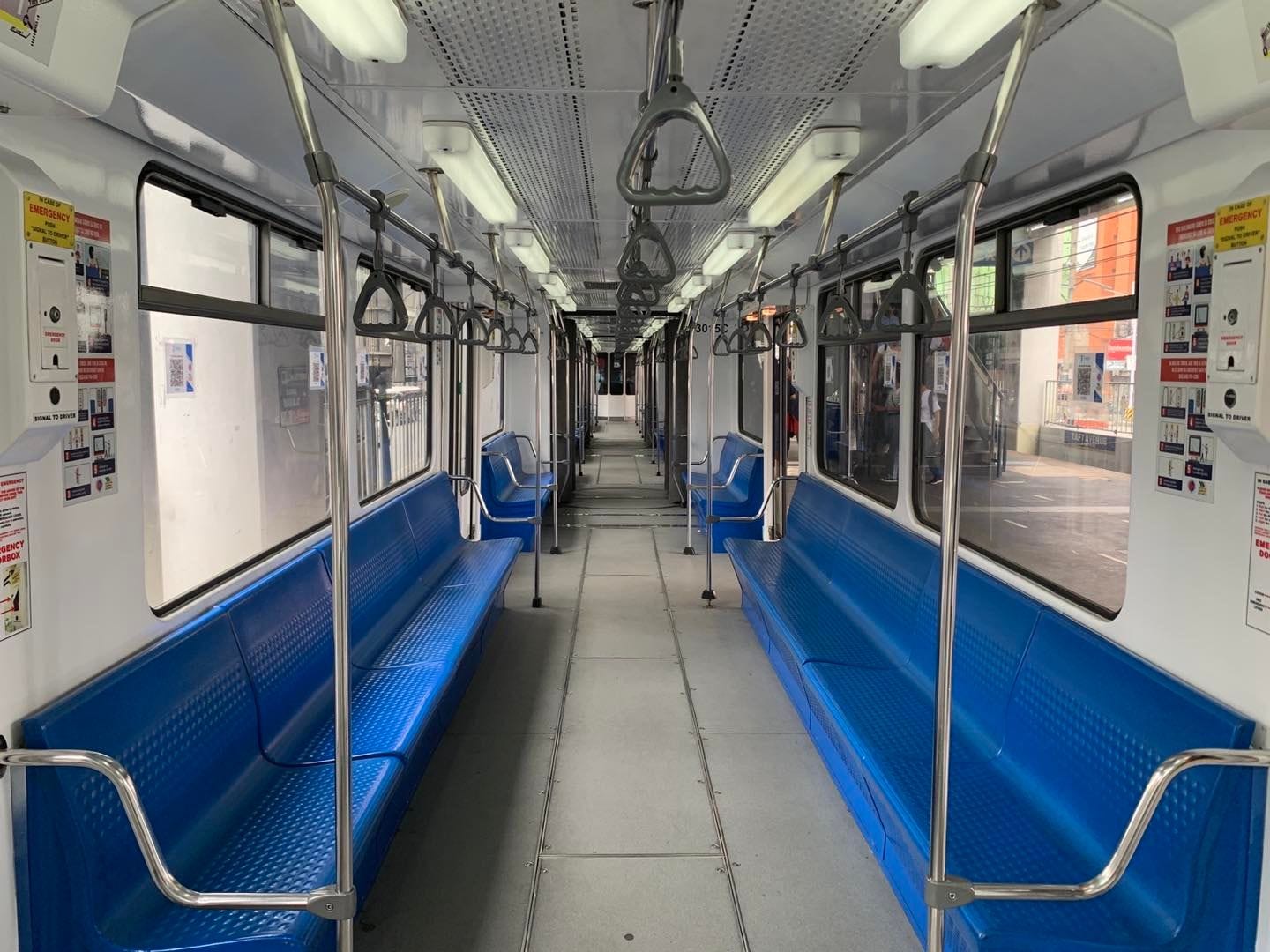 An interior shot of an MRTC 3000 Class train car, showing its blue longitudinal seating, handstraps, handrails, and the infographic stickers on the walls. (Photo: DOTr-MRT3, 31 August 2022)
