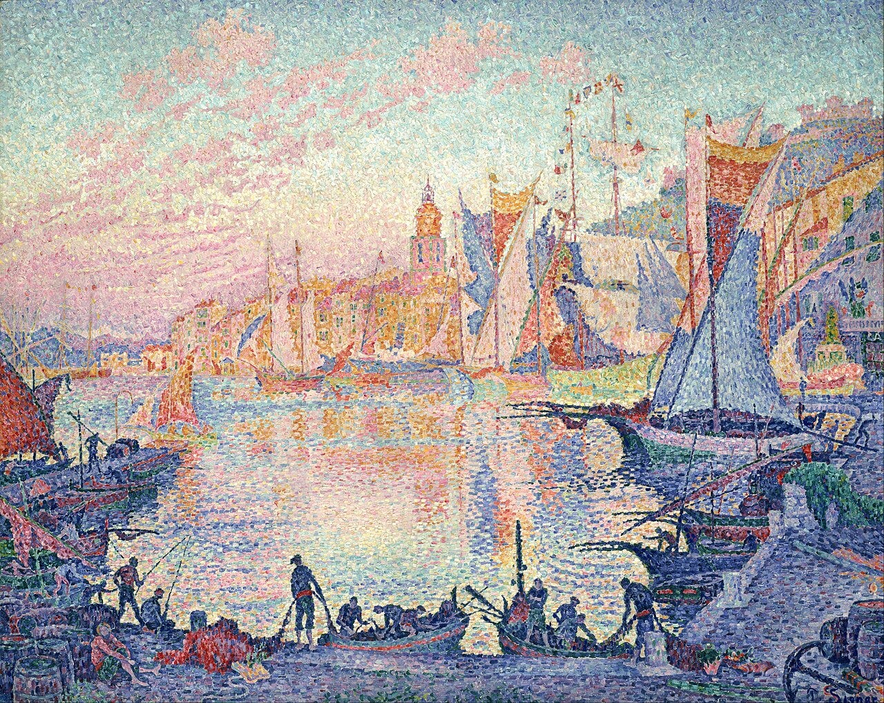 Fishermen at work on a blue quay in the foreground, with sailing boats and the pink and orange houses of the town across the harbor, painted in small dots of color