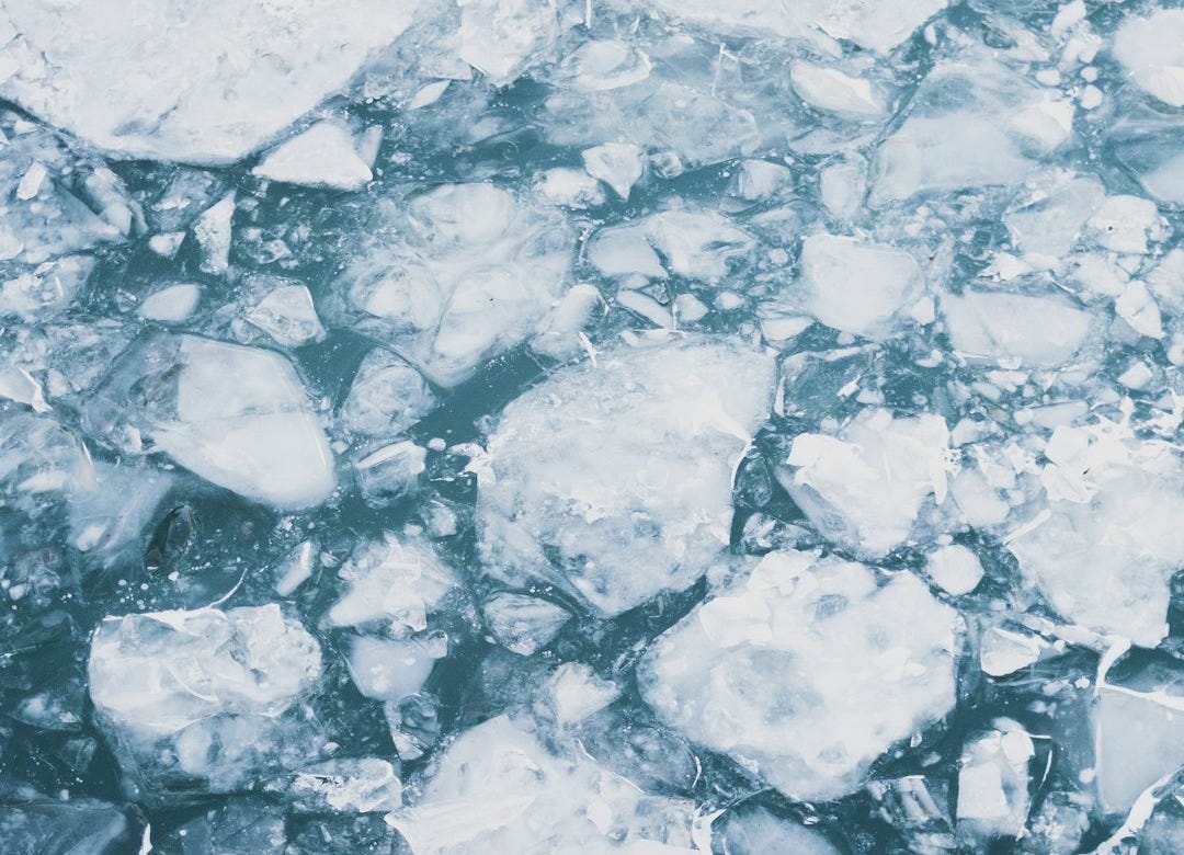 broken snow flakes on water
