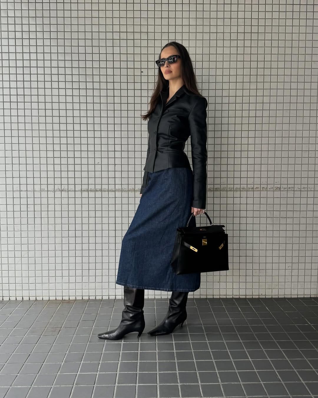 A portrait of Pia Mance in Tokyo in a denim skirt and black blouse.