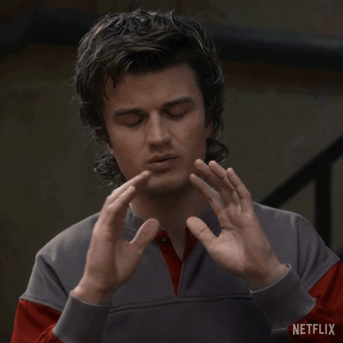 a man covering his face with his hands and the words what on the bottom right