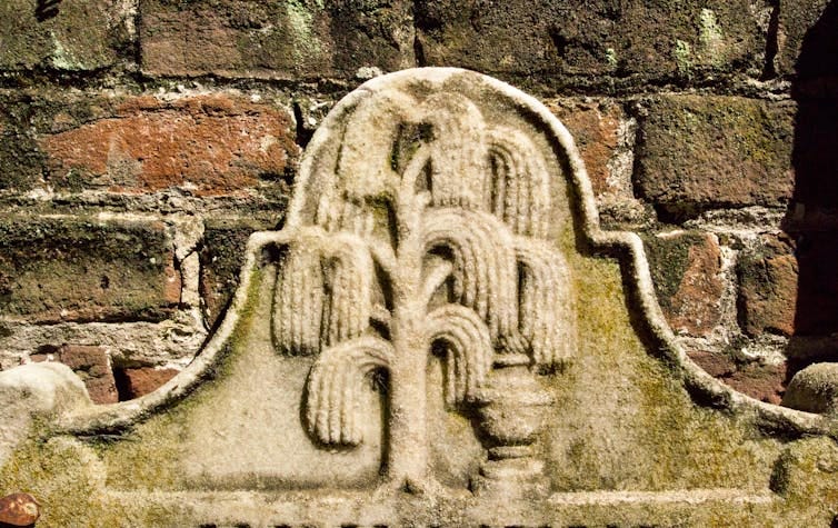 A stone carving of a weeping willow tree.