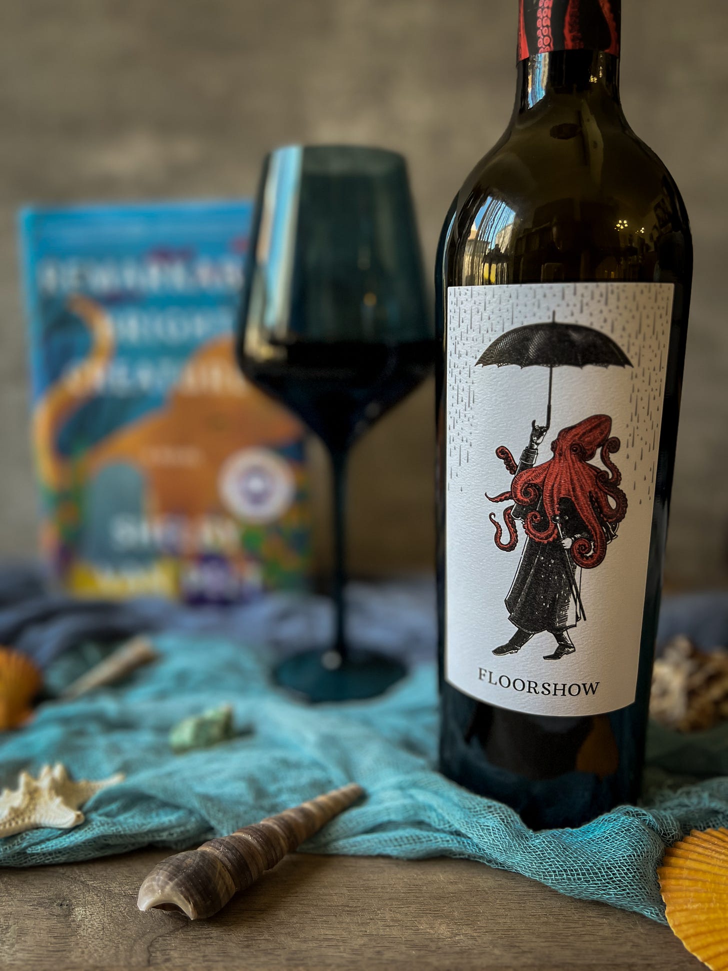 Wine bottle with octopus label and wine glass and Remarkably Bright Creatures in the background