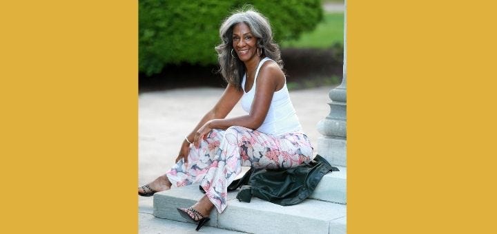 Patti Roberts seated and smiling outdoors