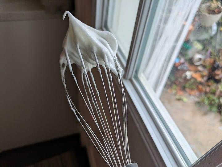 Cake batter in the pan. Beaten egg whites with a squeeze of lemon and some sugar.