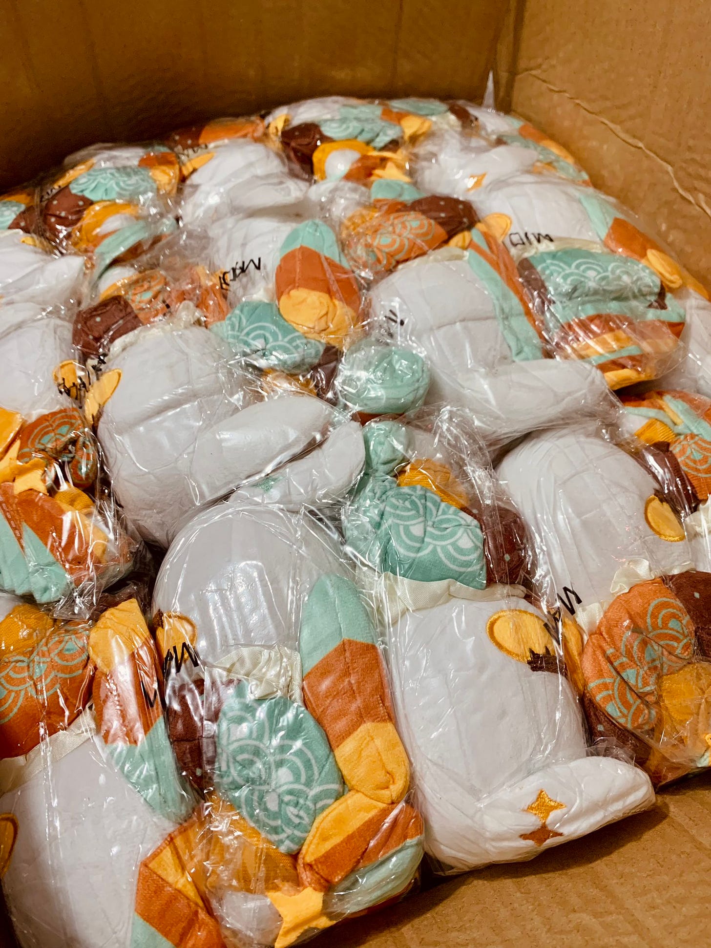 A box filled to the top with hina plush packed tightly like sardines