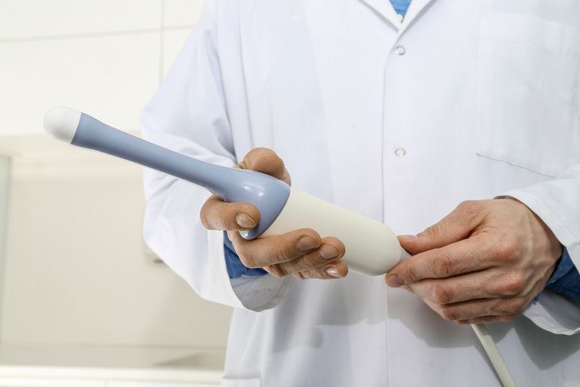 doctor holding a transvaginal ultrasound transducer