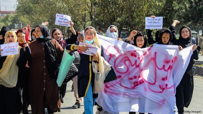Afghan women display placards and chant slogans during a protest they call Stop Hazara genocide, October 1, 2022.