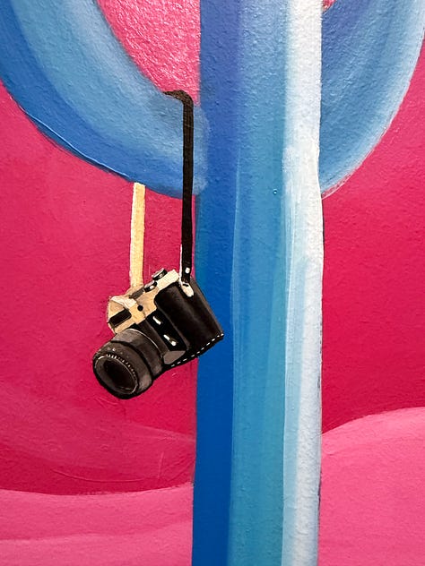Detail shots from Pato’s mural showing two floating televisions with imagery of the moon landing and Mars, alongside a close-up of a vintage camera hanging from a saguaro arm, symbolizing media, storytelling, and perspective in journalism.