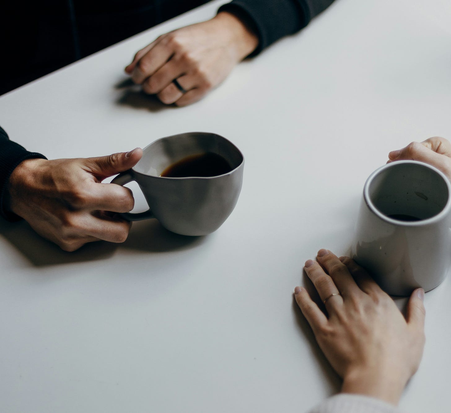 two people having a conversation over coffee two people having a conversation over coffee