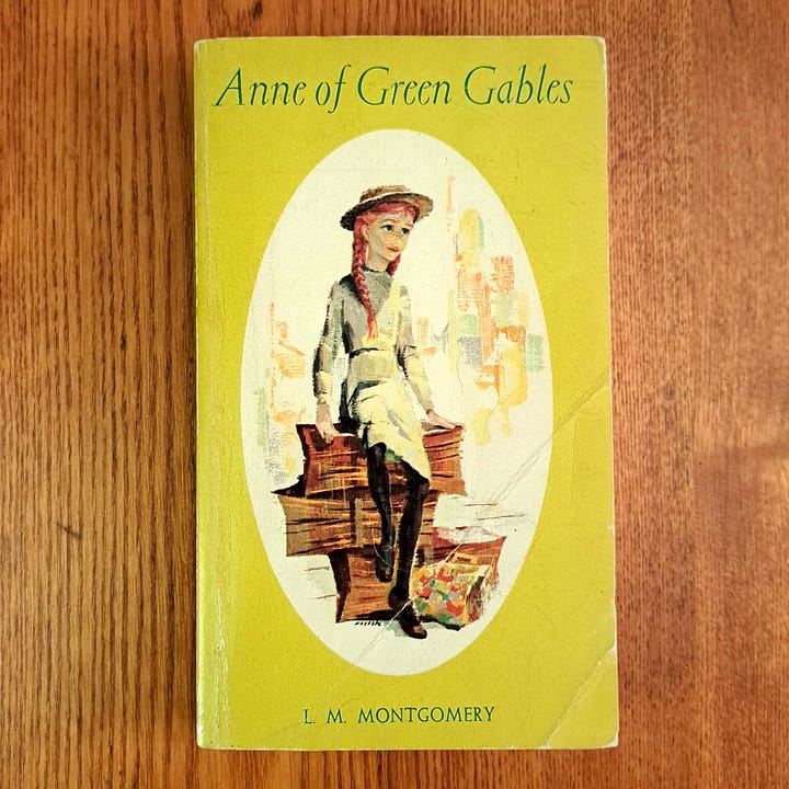 Little House book on 1970s blue & yellow cotton floral fabric, vintage Anne of Green Gables paperback on wood