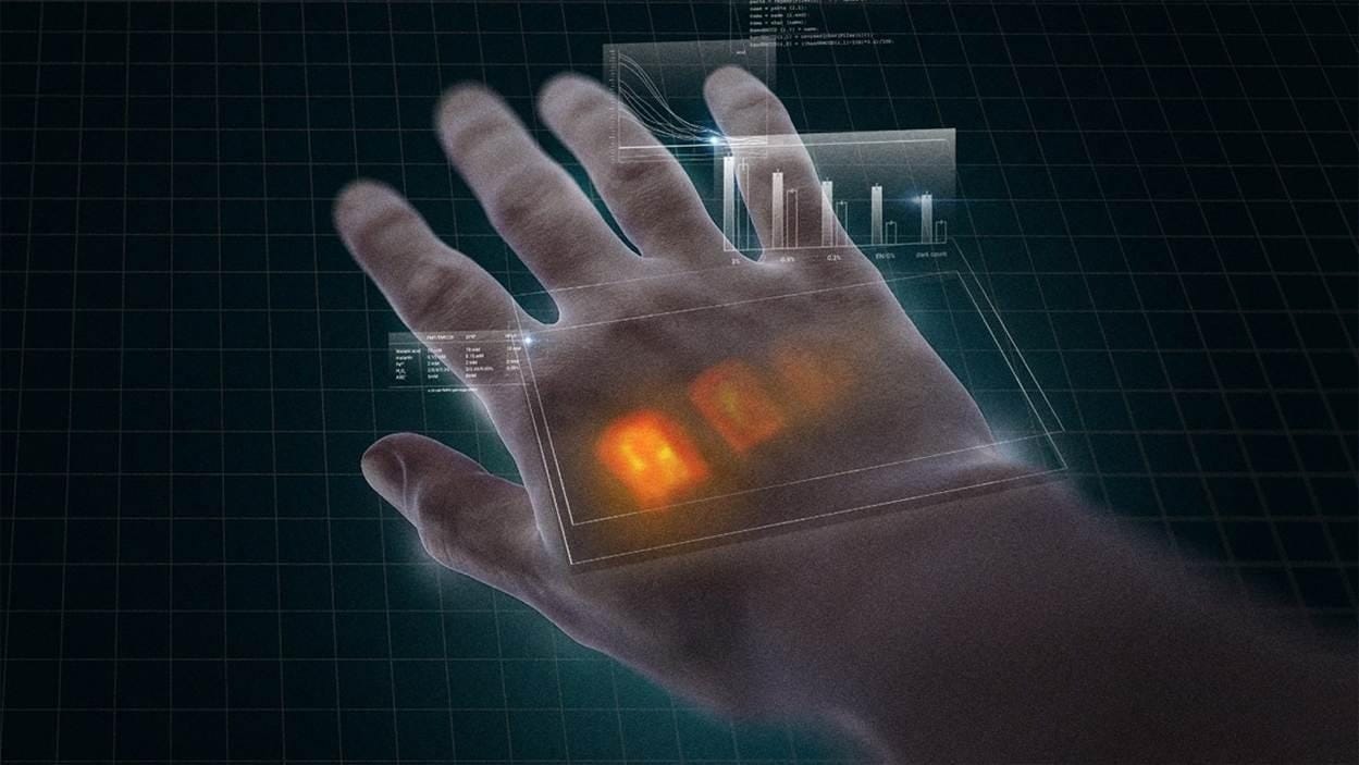 An image of a hand emitting red biophotons 