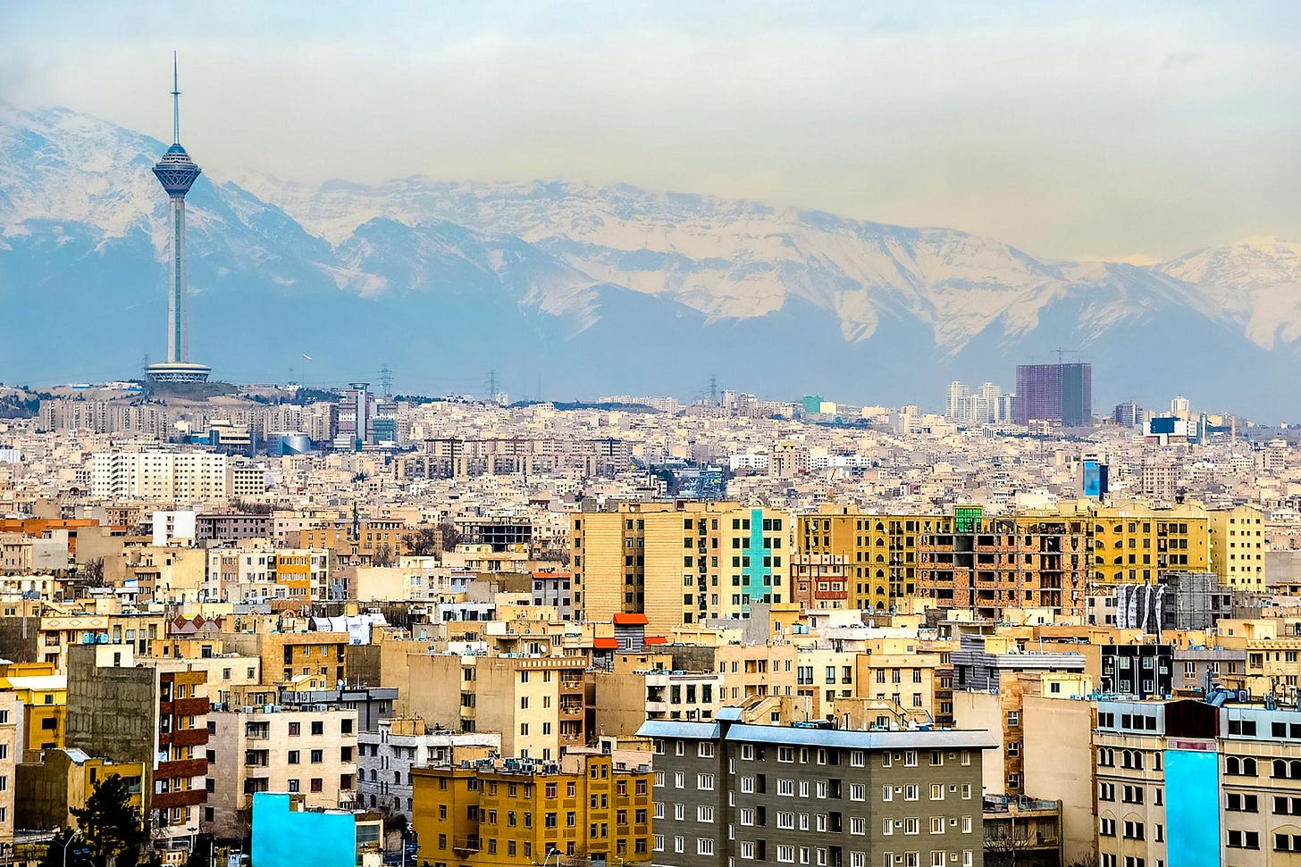 Tehran city skyline with Milad Tower and Alborz mountains background
