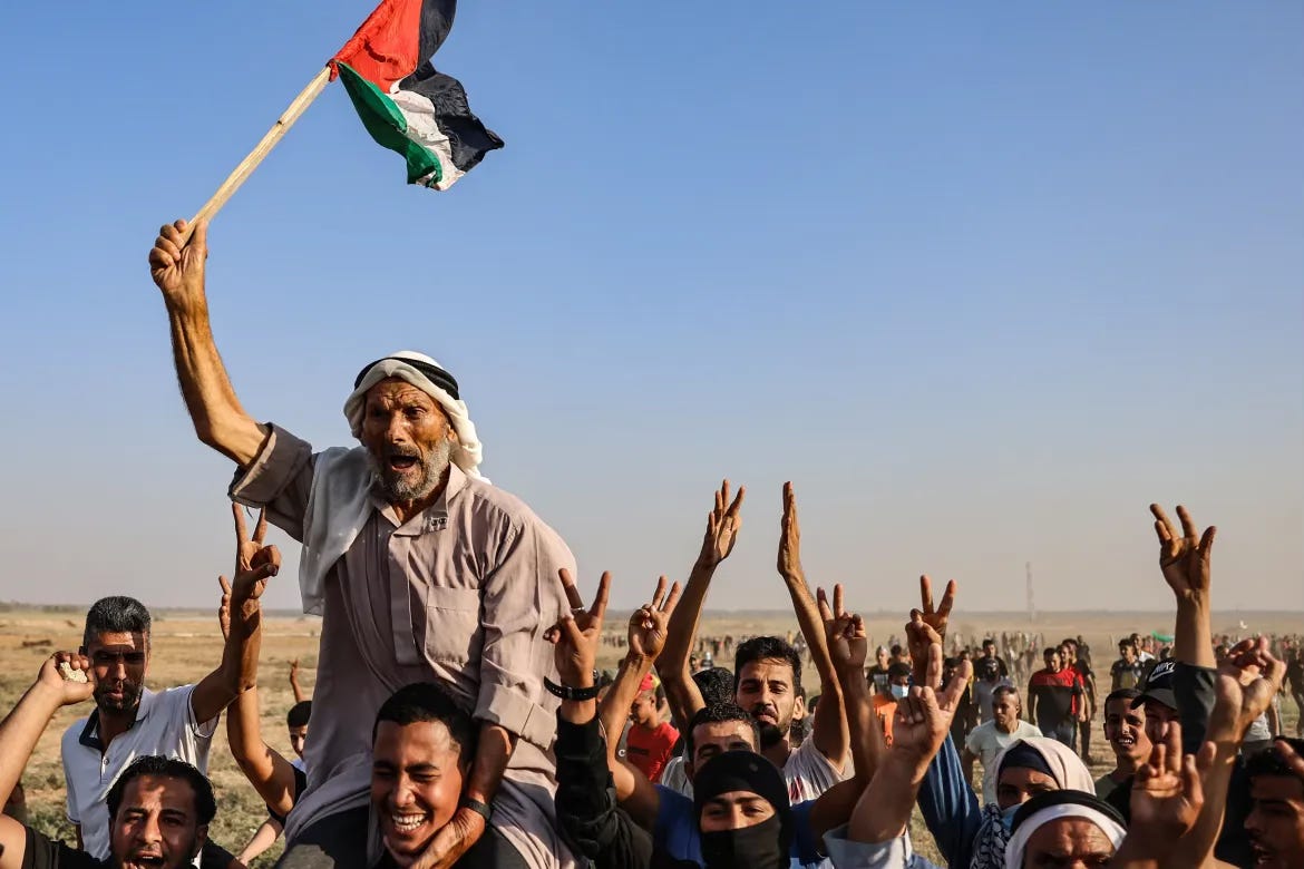 Image of Palestinians protesting in Gaza with flags and banners